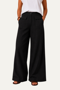 Zeemara black high-waisted wide-leg pants featuring a button front and functional patch pockets on a model