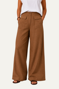 Zeemara brown high-waisted wide-leg pants featuring a button front and functional patch pockets on a model.