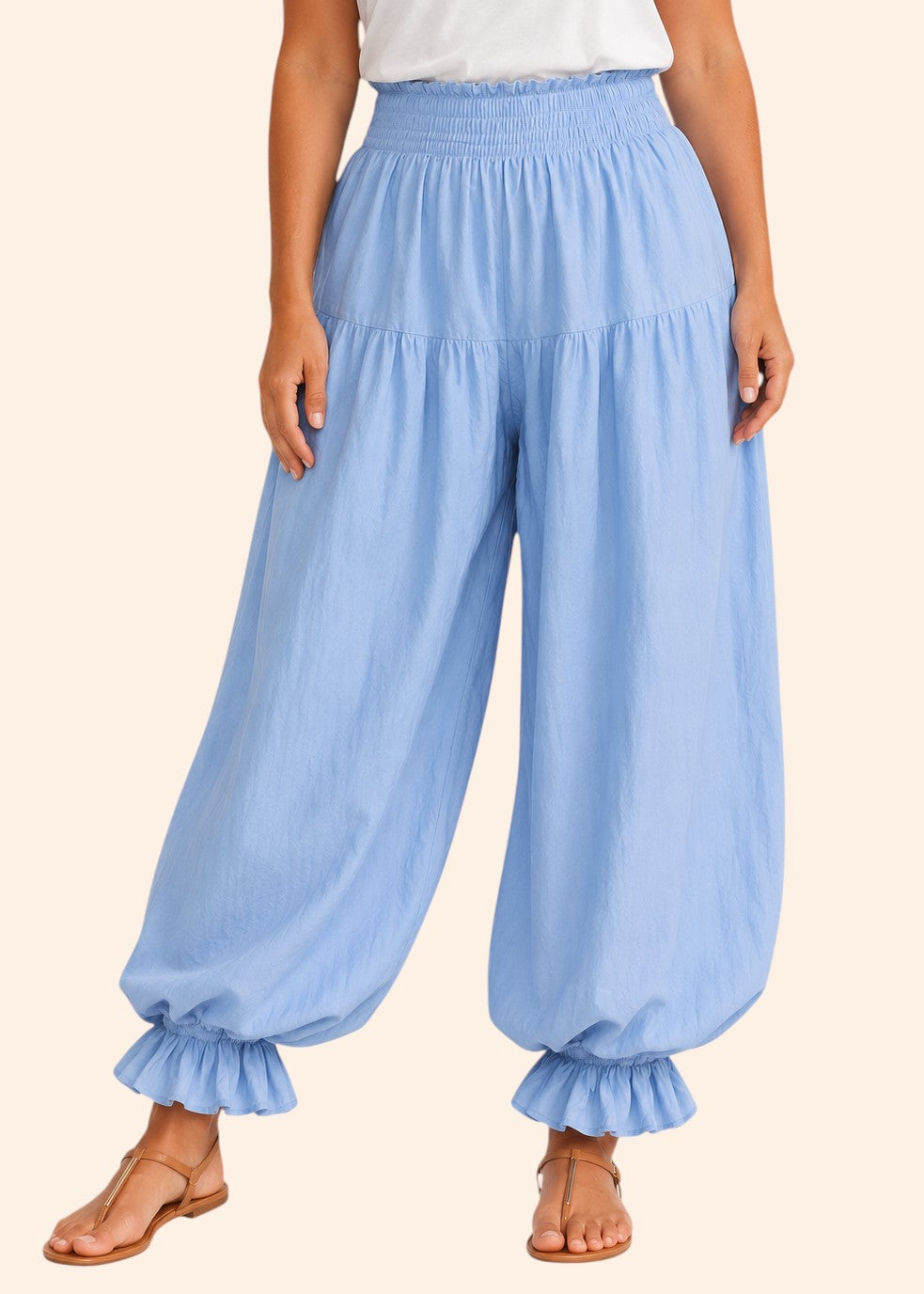 Zeemara light blue balloon pants featuring a shirred elastic waistband, side pockets, and ruffled cuffs on a model.