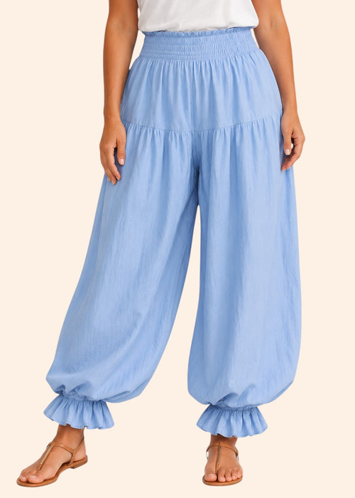 Zeemara light blue balloon pants featuring a shirred elastic waistband, side pockets, and ruffled cuffs on a model.
