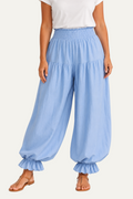 Zeemara light blue balloon pants featuring a shirred elastic waistband, side pockets, and ruffled cuffs on a model.