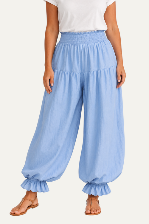 Zeemara light blue balloon pants featuring a shirred elastic waistband, side pockets, and ruffled cuffs on a model.