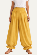 Zeemara mustard balloon pants featuring a shirred elastic waistband, side pockets, and ruffled hem detail.