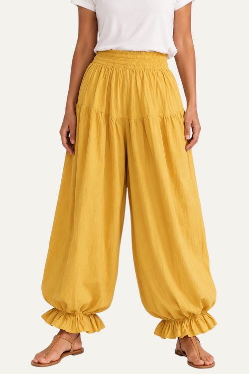 Zeemara mustard balloon pants featuring a shirred elastic waistband, side pockets, and ruffled hem detail.