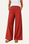 Zeemara red high-waisted wide-leg pants with button front and patch pockets worn with gold sandals