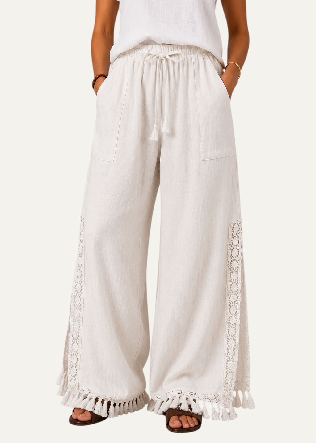 Zeemara white wide-leg pull-on pants featuring side crochet panels, deep pockets, and a fringed tassel hem.